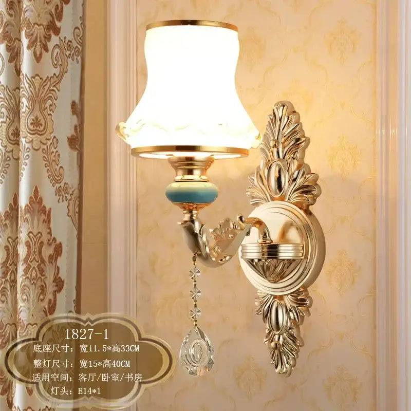 Ornate gold crystal wall sconce with white fabric lampshade, turquoise accent, and dangling crystal teardrop decorbites crystal wall