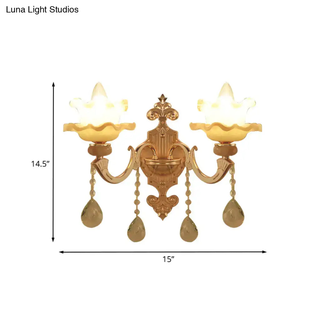 Ornate gold crystal wall sconce with frosted glass shade and lotus-shaped glass accents for living room lighting