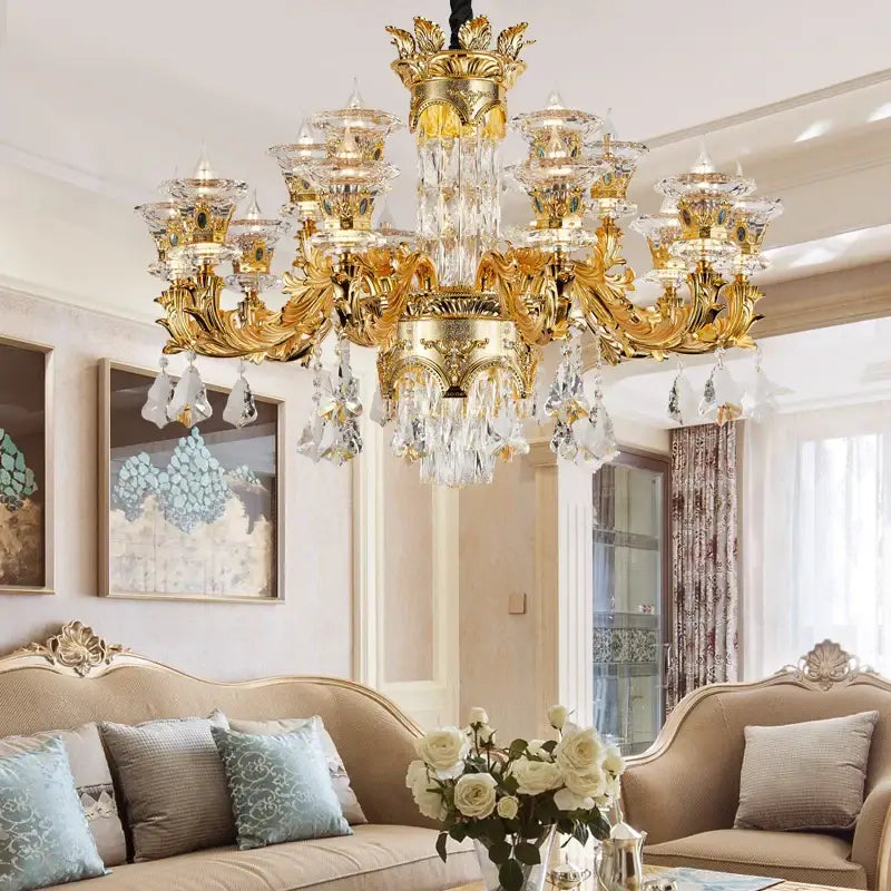 Ornate gold decorbites crystal chandelier with intricate detailing and cascading clear crystal droplets for living room luxury