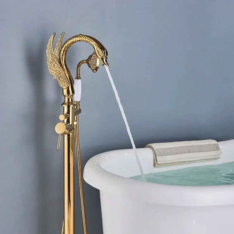 Ornate gold swan freestanding bathtub faucet with intricate wing detailing and polished brass finish decorbites gold swan