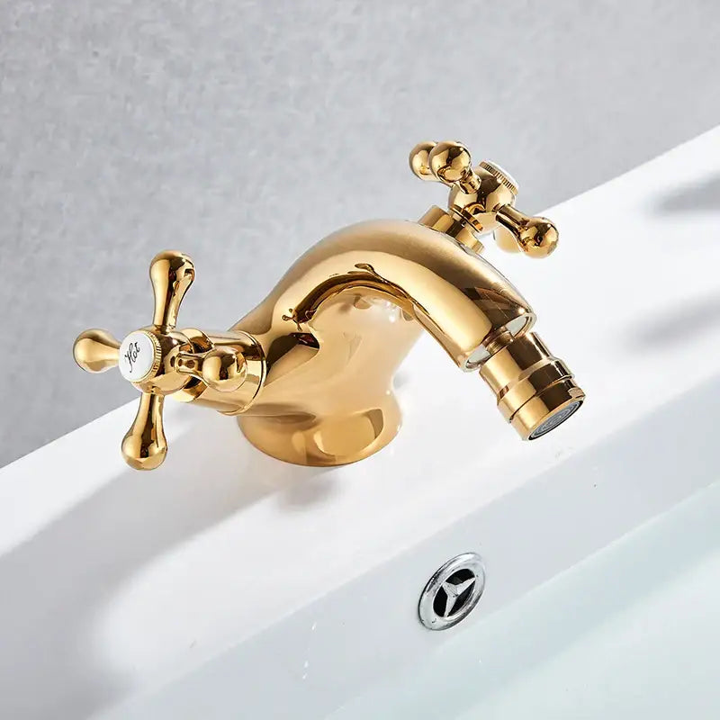 Ornate gold dual handle bidet faucet with vintage cross handles and polished metallic finish for vessel sink decorbites dual handle
