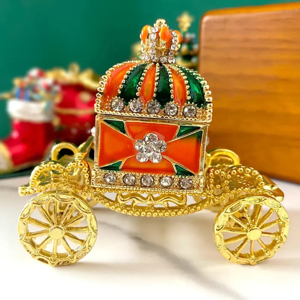 Ornate gold enamel crown jewelry box carriage with vibrant orange and green enamel accents for bedroom decor