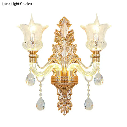 Ornate gold floral wall lamp featuring clear crystal glass teardrop pendants and frosted tulip shades for bedroom use
