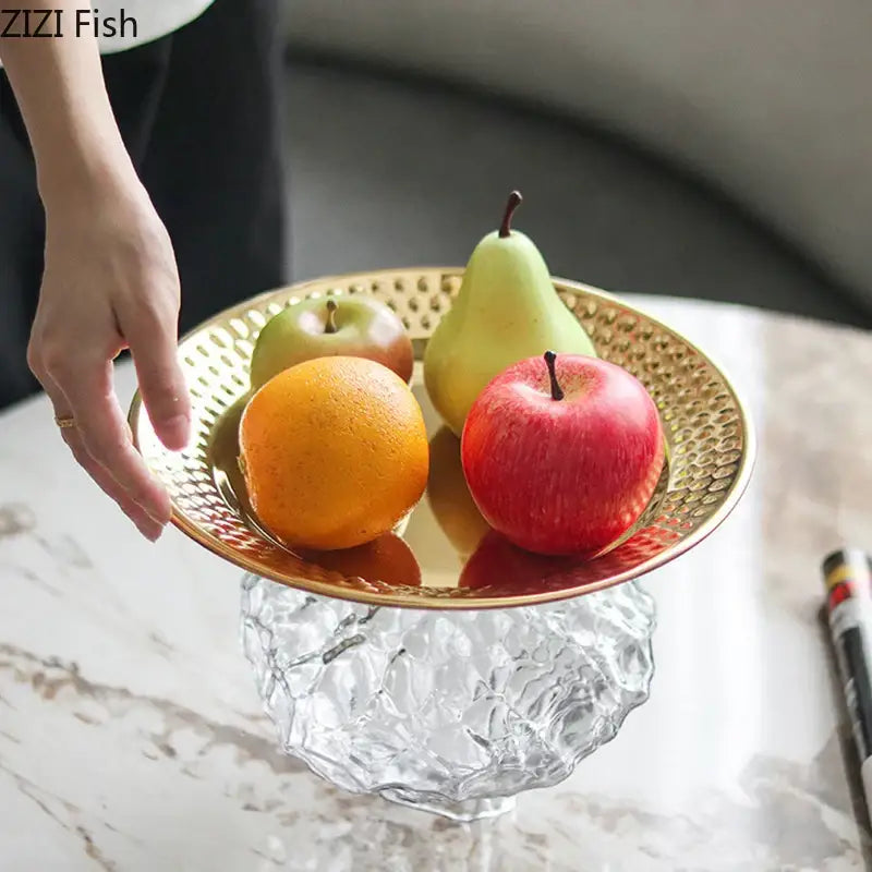 Ornate gold-toned hammered metal fruits bowl with clear textured glass pedestal base for dining room desserts