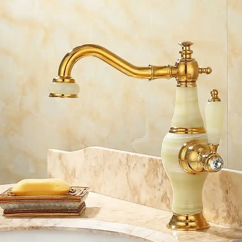 Elegant gold bathroom basin sink faucet with curved spout, cream onyx body, and ornate brass details for jade basin