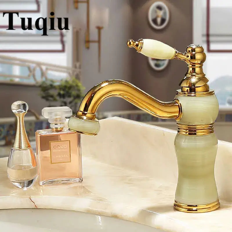 Ornate gold and jade bathroom basin sink faucet with green ceramic body and matching handle featuring elegant curves