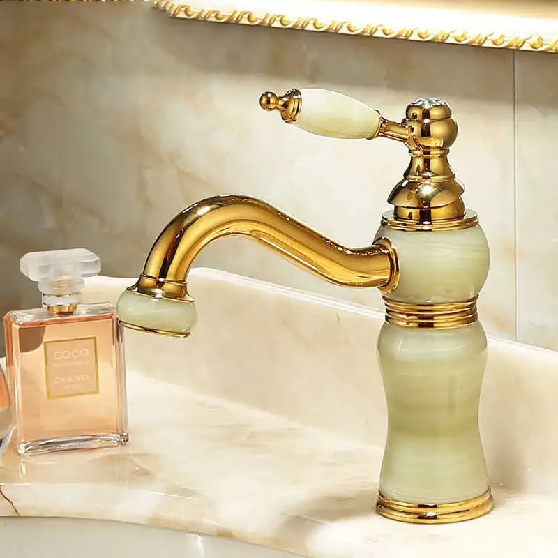 Ornate gold bathroom basin sink faucet with jade-green marble accents and classic design for jade bathroom basin use