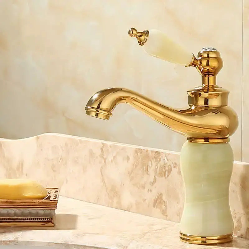 Ornate gold and green jade bathroom basin sink faucet with gold finish pale green jade base and off-white ceramic handle