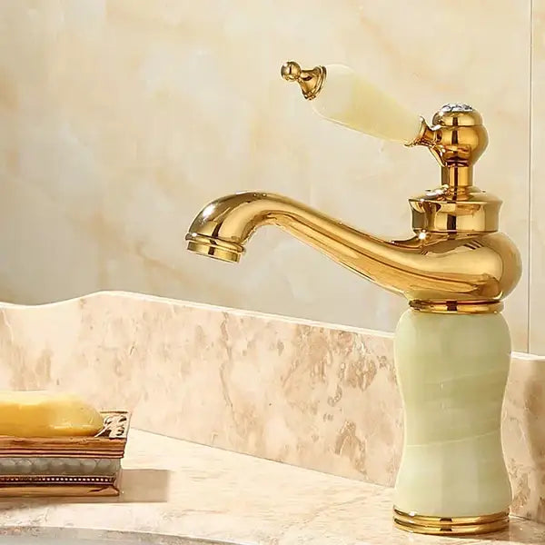 Ornate gold and pale green jade bathroom basin sink faucet with curved spout and matching handle for luxury basin sink use