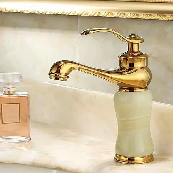 Ornate gold and green jade bathroom basin sink faucet with gold-finished polished brass spout and ceramic base