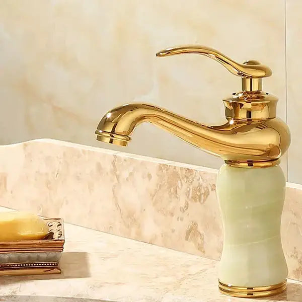 Ornate gold and green jade bathroom basin sink faucet with polished brass finish and jade ceramic base