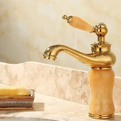 Ornate gold and green jade bathroom basin sink faucet with polished brass finish and amber translucent ceramic handle