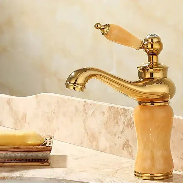 Ornate gold and green jade bathroom basin sink faucet with polished brass finish and amber translucent ceramic handle