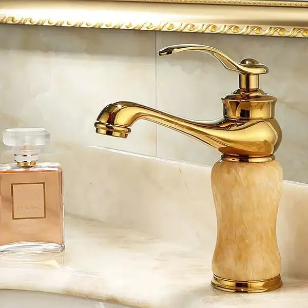 Ornate gold bathroom basin sink faucet with polished brass finish and green jade marble-like base