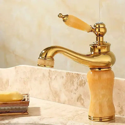 Ornate gold and green jade bathroom basin sink faucet with polished brass finish and amber marble handle curved spout