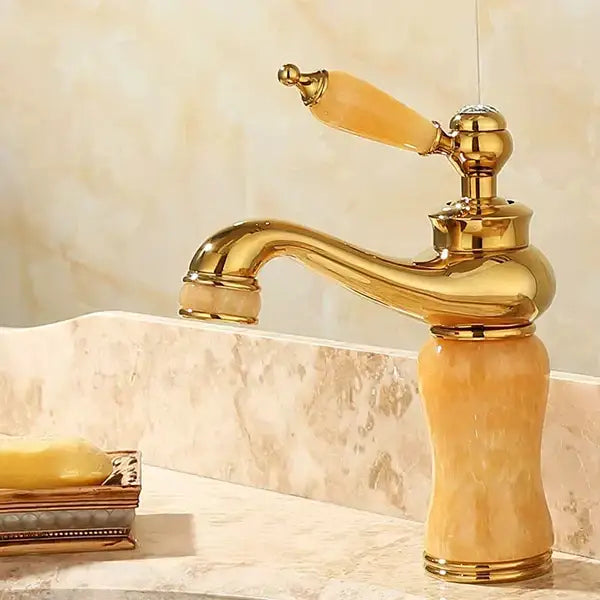 Ornate gold and green jade bathroom basin sink faucet with polished brass finish and amber marble handle curved spout