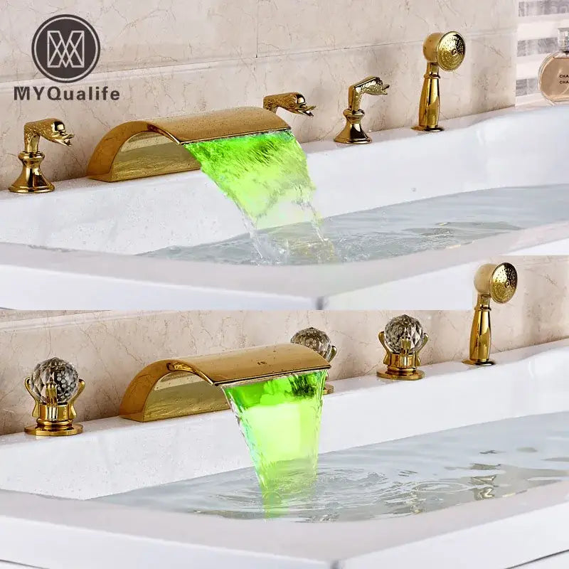 Ornate gold-toned led waterfall bath tub faucet with sculptural handles and handshower for bathroom tub faucet setup