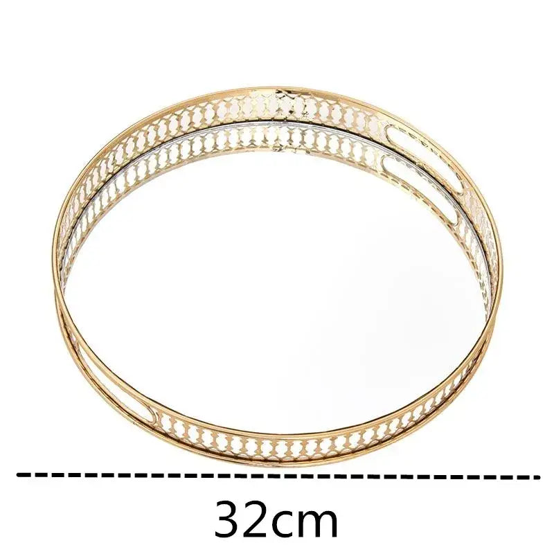 Gold-toned ornate storage tray with intricate openwork and a gold mirror glass center for bedroom jewelry decor