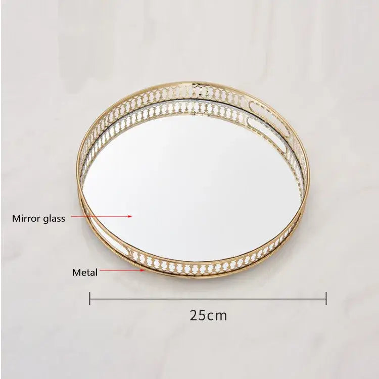 Ornate gold mirror glass storage tray with gold-toned oval mirror and intricate cut-out metal frame for jewelry decor
