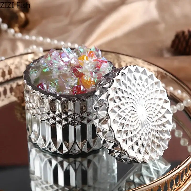 Silver faceted glass storage jar with intricate geometric lid design for ornate gold and rose gold bedroom decor