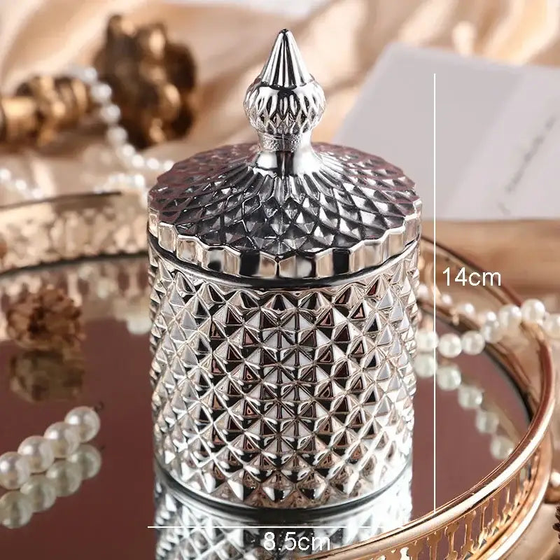 Silver diamond-cut glass storage jar with ornate matching lid and pointed finial for elegant bedroom decor