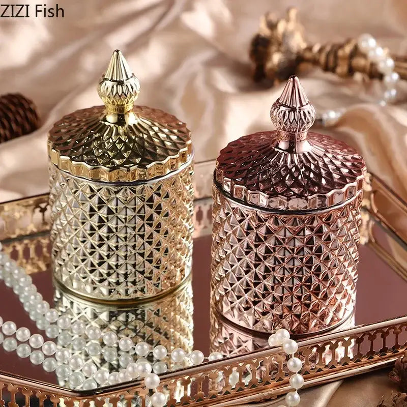 Two ornate faceted glass storage jars with gold and rose gold lids sit on a mirrored tray for bedroom decor