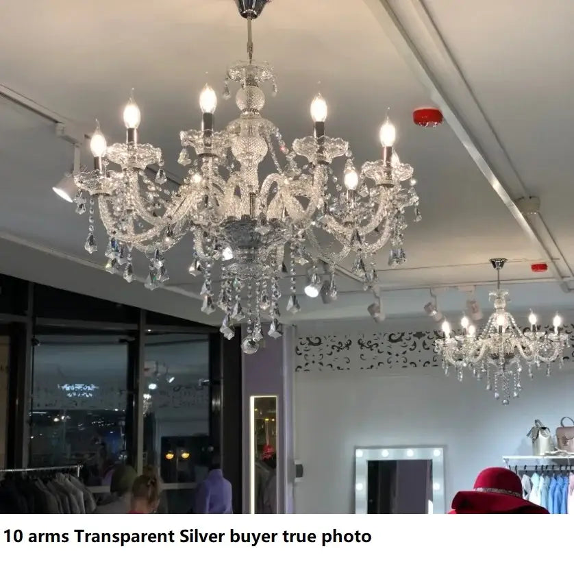 A sparkling transparent silver decorbites crystal led chandelier with ten ornate arms and crystal droplets for living rooms