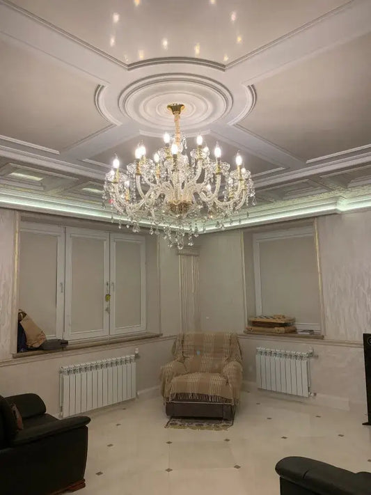 A grand ornate gold and silver decorbites crystal led chandelier with decorative ceiling mount for living room lighting