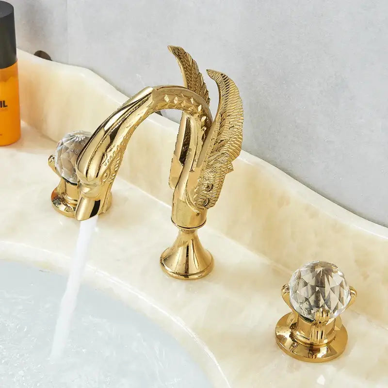 Ornate gold swan basin faucet with crystal handles featuring intricate feather detailing for bathroom decorbites gold swan