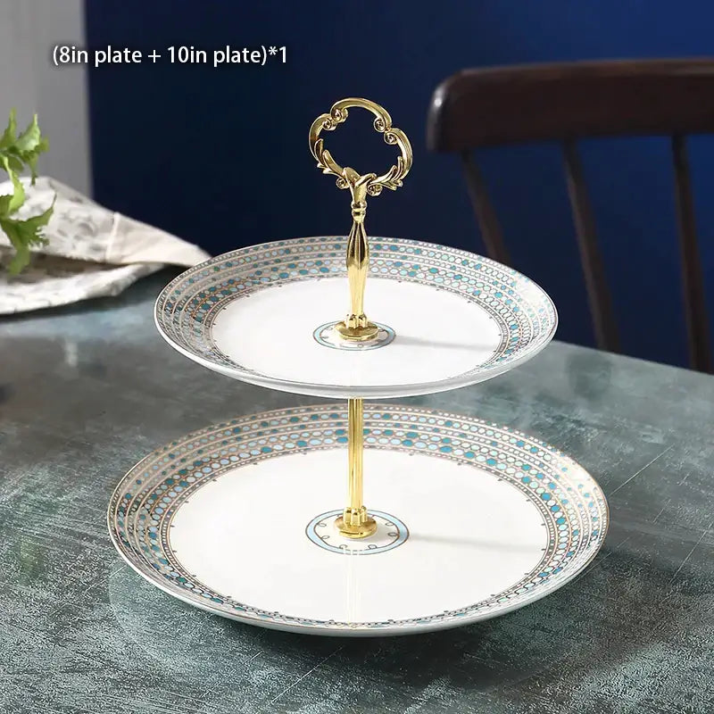 Elegant two-tiered fruit plates set with gold ornate handle and white ceramic plates featuring teal silver geometric borders