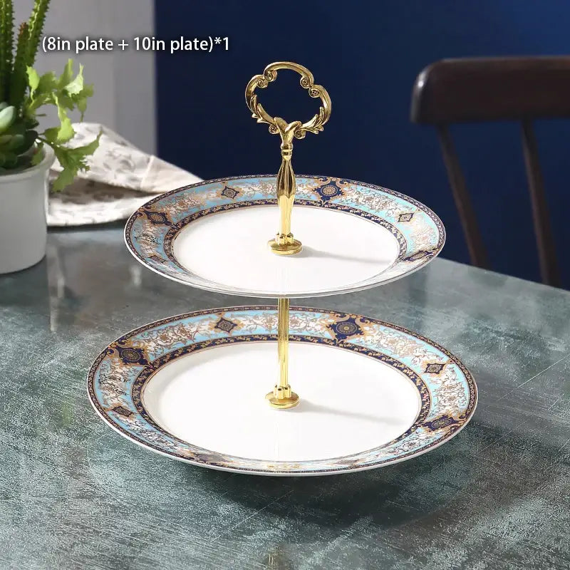 Elegant two-tiered fruit plates set with ornate gold handle and decorative blue brown and white porcelain plates