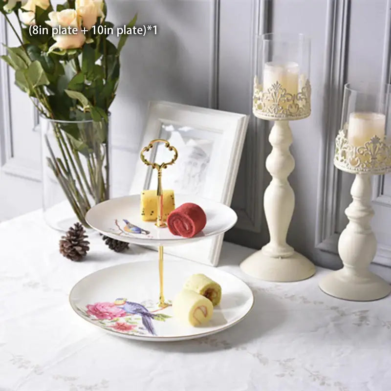 Two-tiered porcelain fruit plates set with gold-tone handle and floral bird illustrations for dining room use