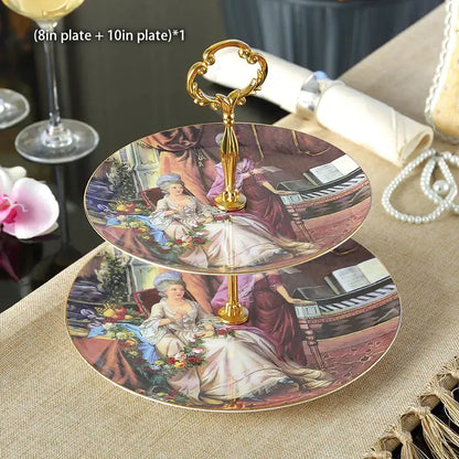 Two-tiered fruit plates set with ornate gold handle and vintage porcelain plates featuring 18th-century ladies gowns