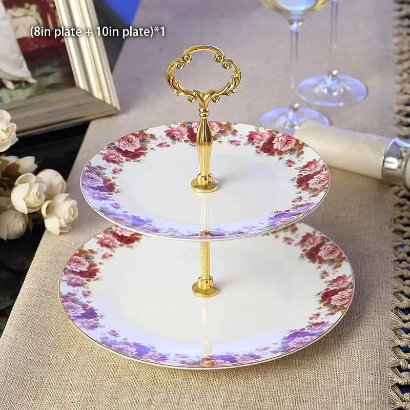 Elegant two-tiered fruit plates set with gold ornate handle and floral-patterned porcelain plates in soft pink and purple