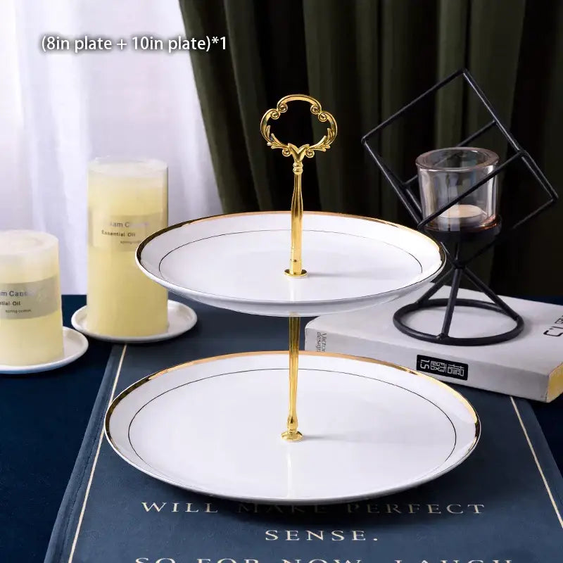 Ornate gold three tiered metal stand with white ceramic fruit plates set edged in gold trim for dining room use