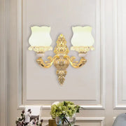 Ornate gold wall light fixture with two frosted glass bloom shades designed for living room use with fixture width details