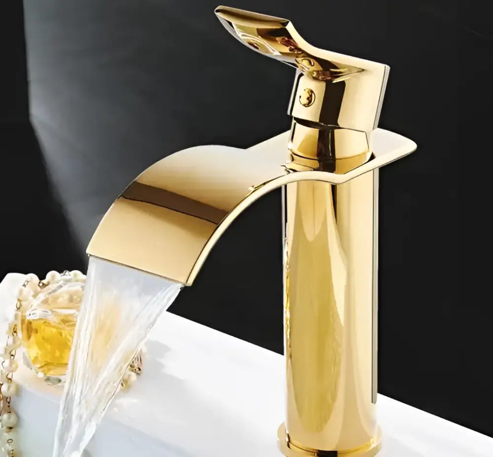 Ornate gold waterfall bathroom faucet with floral basin mixer tap featuring a polished brass decorbites gold waterfall design