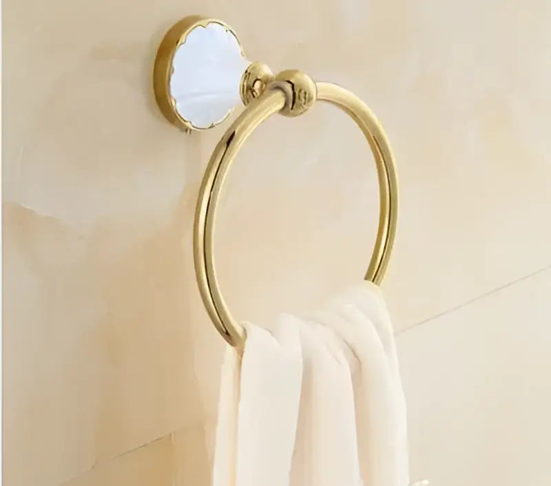Ornate gold and white ceramic towel ring with polished metal finish from decorbites bathroom accessories set