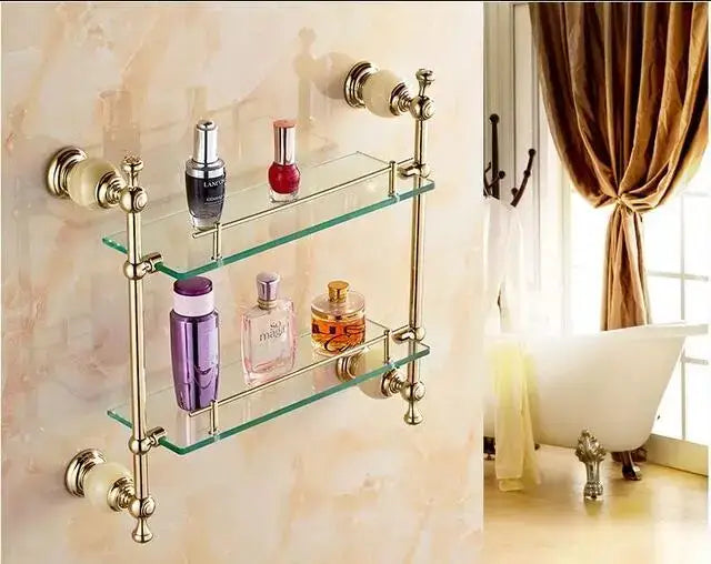 Ornate gold and white ceramic double-tiered glass shelf with brass finish and decorative knobs in brass jade bathroom hardware set
