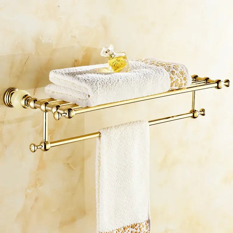 Gold-toned double-tier bathroom towel rack with ornate finials and polished brass finish in decorbites brass jade hardware set