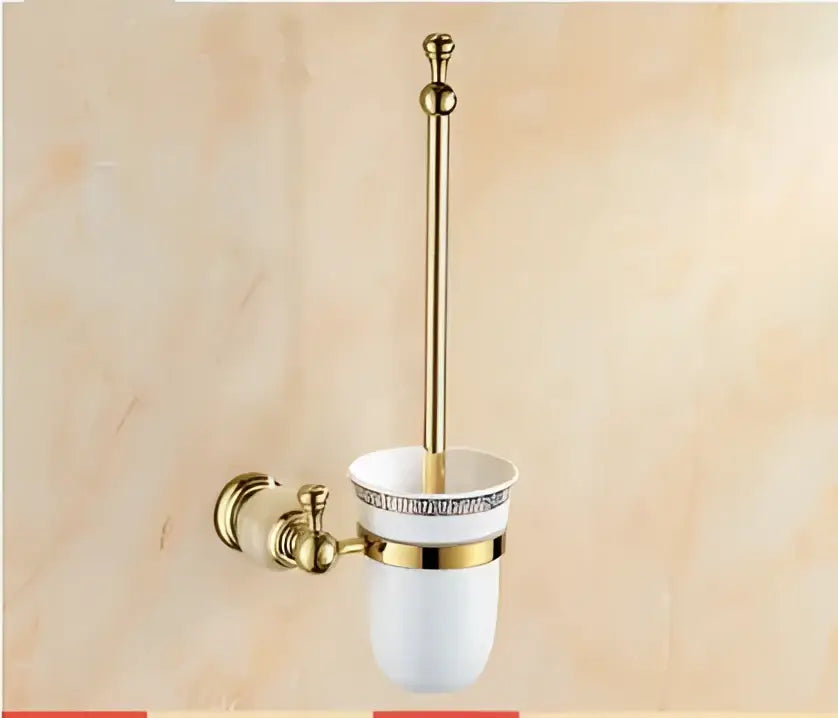 Ornate gold-toned toilet brush holder with white ceramic base and decorative trim from decorbites brass jade bathroom hardware set