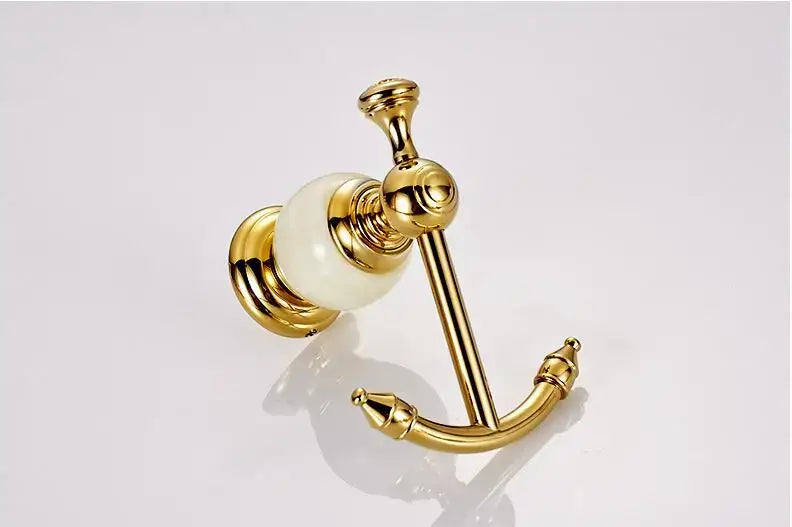 Ornate gold-toned anchor-shaped towel rack with white marble accent from decorbites brass jade bathroom hardware set
