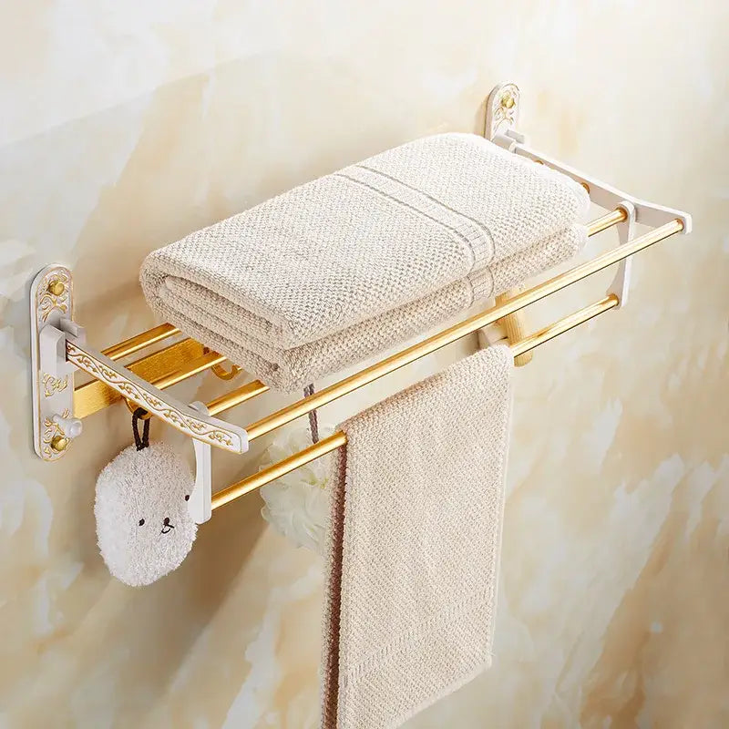 Ornate gold and white floral bathroom accessories set featuring gold-toned towel rack with white brackets and towels decorbites bathroom
