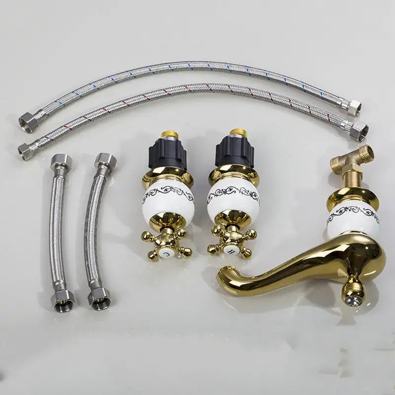 Ornate gold and white porcelain bathroom faucet set with gold finish and white ceramic knobs featuring black detailing