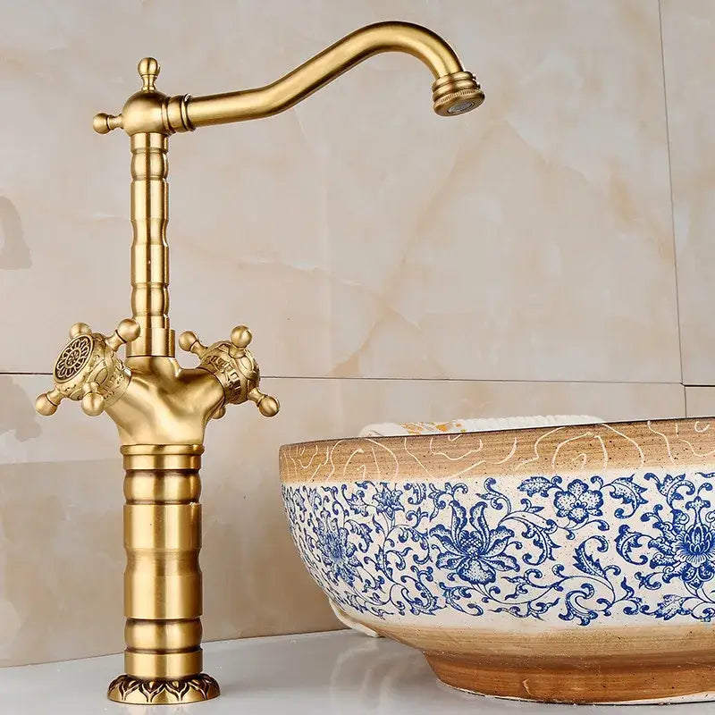 Ornate golden brass carved bathroom faucet with decorbites brass carved finish and decorative cross handles for hot and cold mixer tap