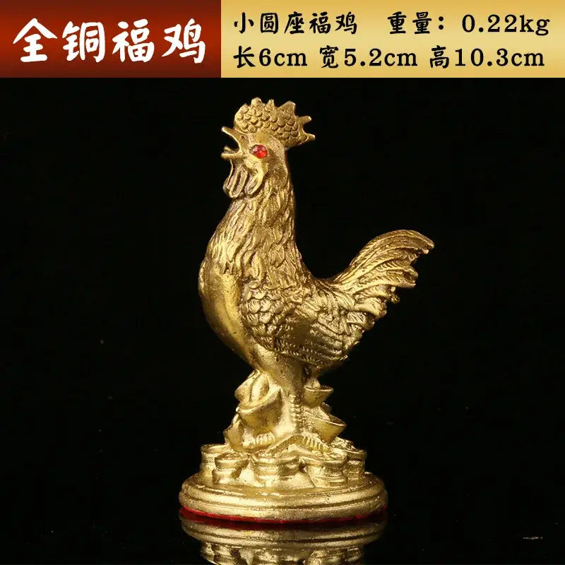 Ornate golden brass rooster figurine with red gemstone eye on a coin-adorned base for office decorbites brass rooster decor