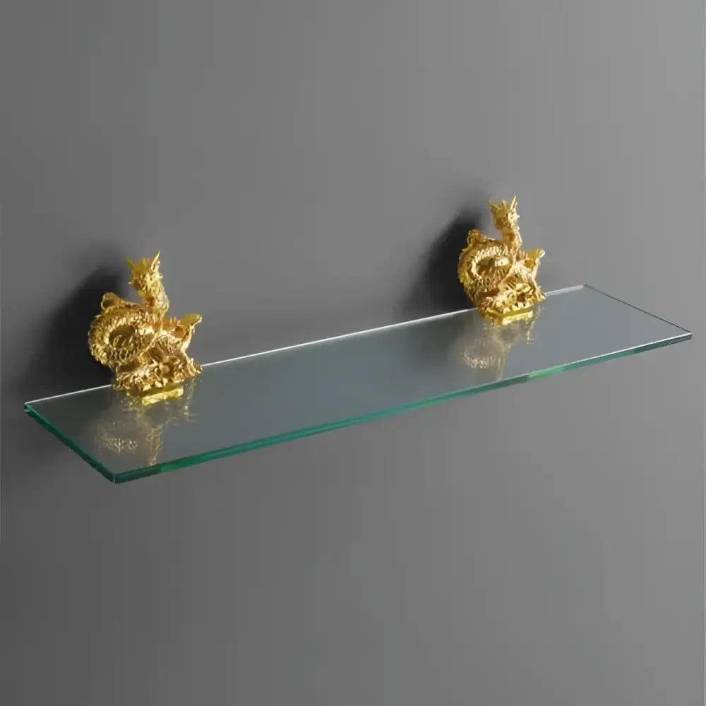 Ornate golden dragon bathroom hardware set featuring a sleek transparent glass shelf with white ceramic accents