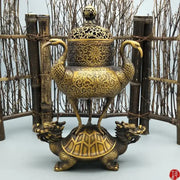 Ornate golden incense burner with intricate floral patterns featuring phoenix handles on a dragon tortoise crane base decorbites dragon tortoise
