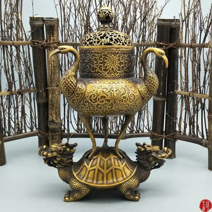 Ornate golden incense burner with intricate floral patterns featuring phoenix handles on a dragon tortoise crane base decorbites dragon tortoise