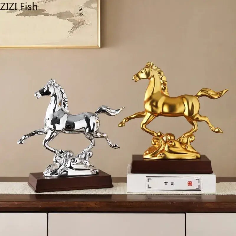 Two polished metallic horse mascot figurines in silver and golden on ornate bases for living room decor